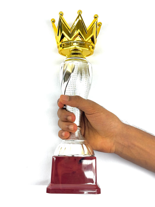 Royal-themed trophy with golden crown, silver column, and red square base