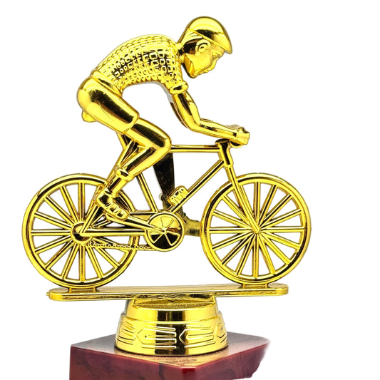 Golden cyclist trophy on wooden base for cycling competitions and sports awards