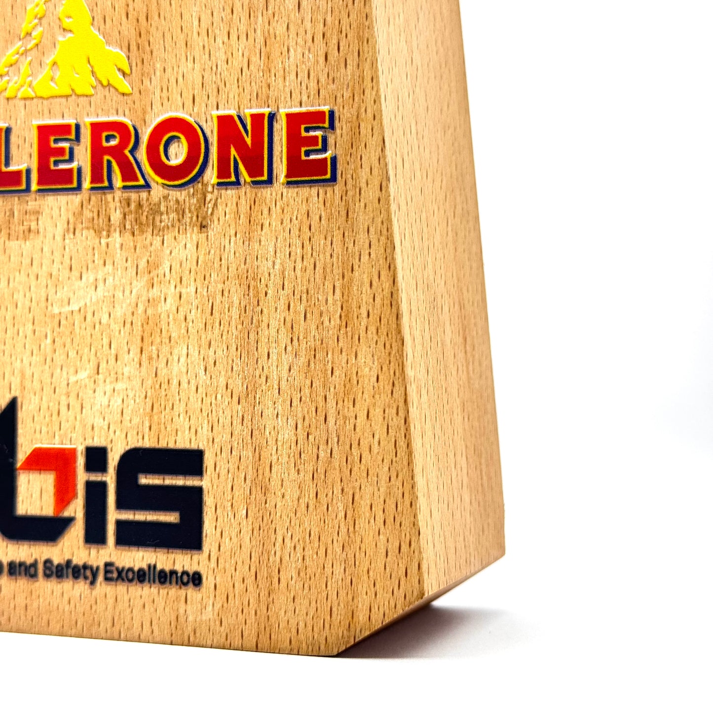 Side perspective focusing on the wooden base of a crystal trophy, emphasizing the sharp edges and smooth surface.