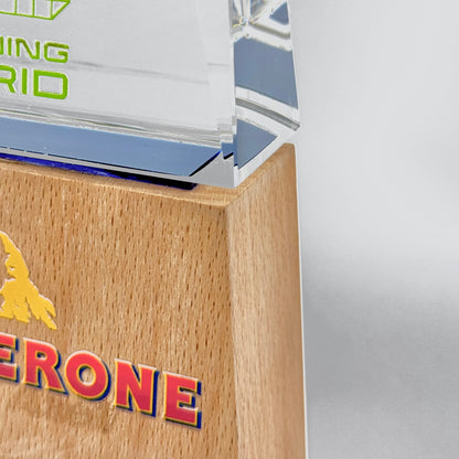 Close-up of a polished wooden award base attached to a crystal top, showcasing refined texture and finish
